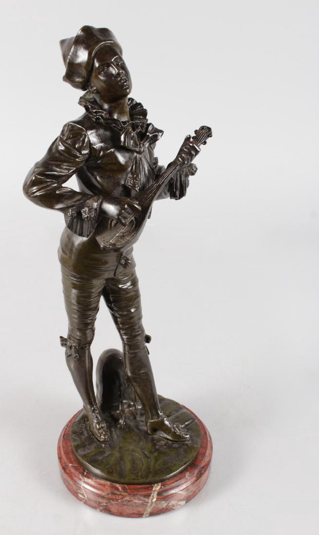 ADOLPHE JEAN LAVERGNE (19TH CENTURY) FRENCH A GOOD: ADOLPHE JEAN LAVERGNE (19TH CENTURY) FRENCH A GOOD BRONZE OF A YOUNG MAN playing a mandolin. Signed, on a circular marble base. 14ins high.