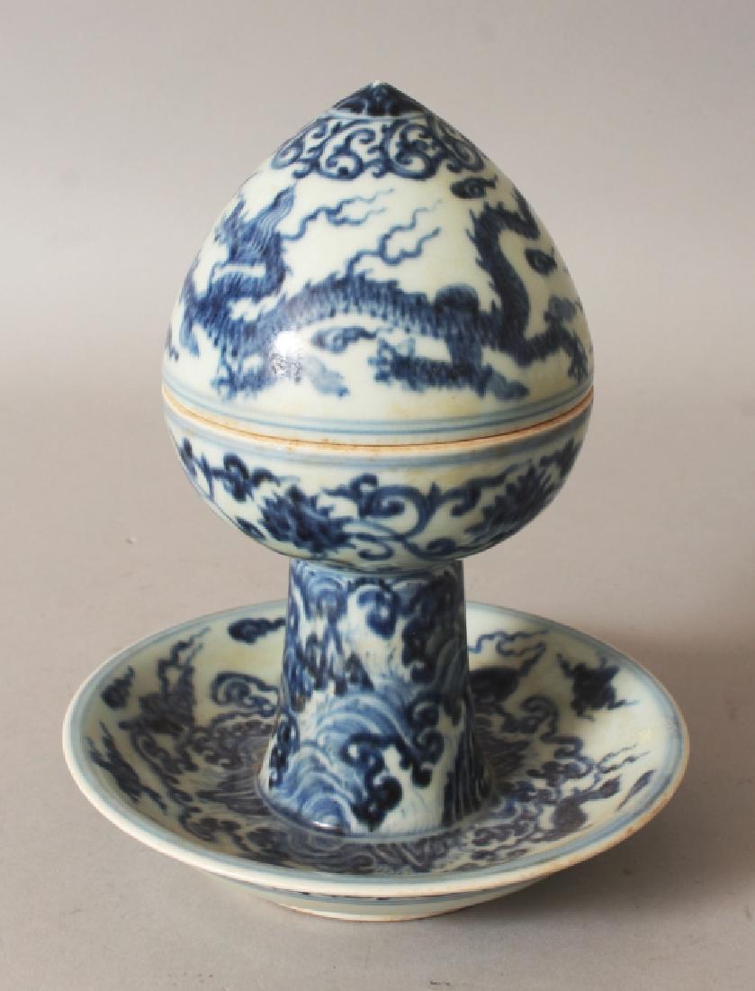 AN UNUSUAL CHINESE YUAN STYLE BLUE & WHITE PORCELAIN: AN UNUSUAL CHINESE YUAN STYLE BLUE & WHITE PORCELAIN BOWL & COVER, supported on a dish-form base and with a peak-domed cover, decorated with dragons and lotus above waves and clouds, 6.3in diameter at