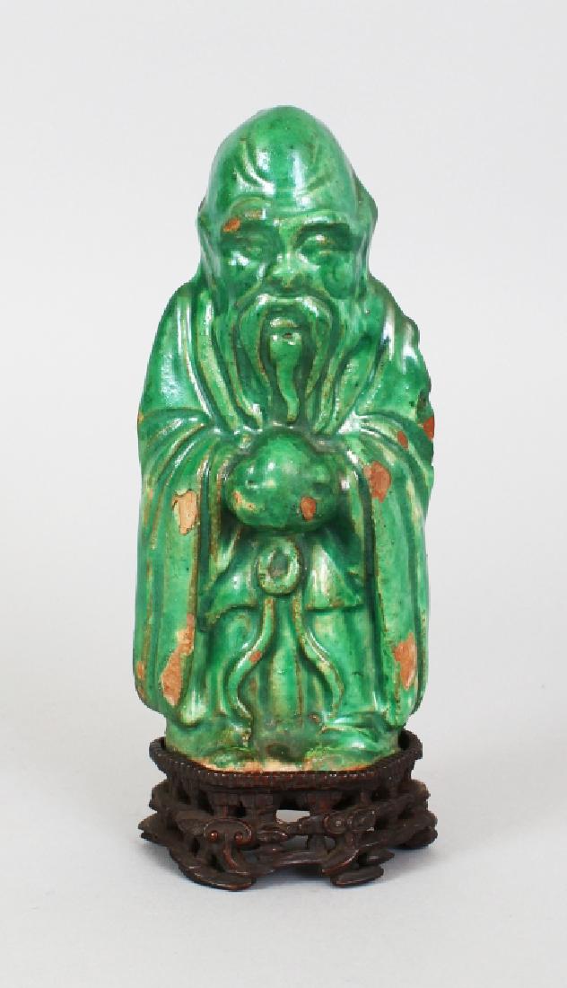 A CHINESE MING DYNASTY GREEN GLAZED FIGURE OF SHOU LAO, (1 of 8)