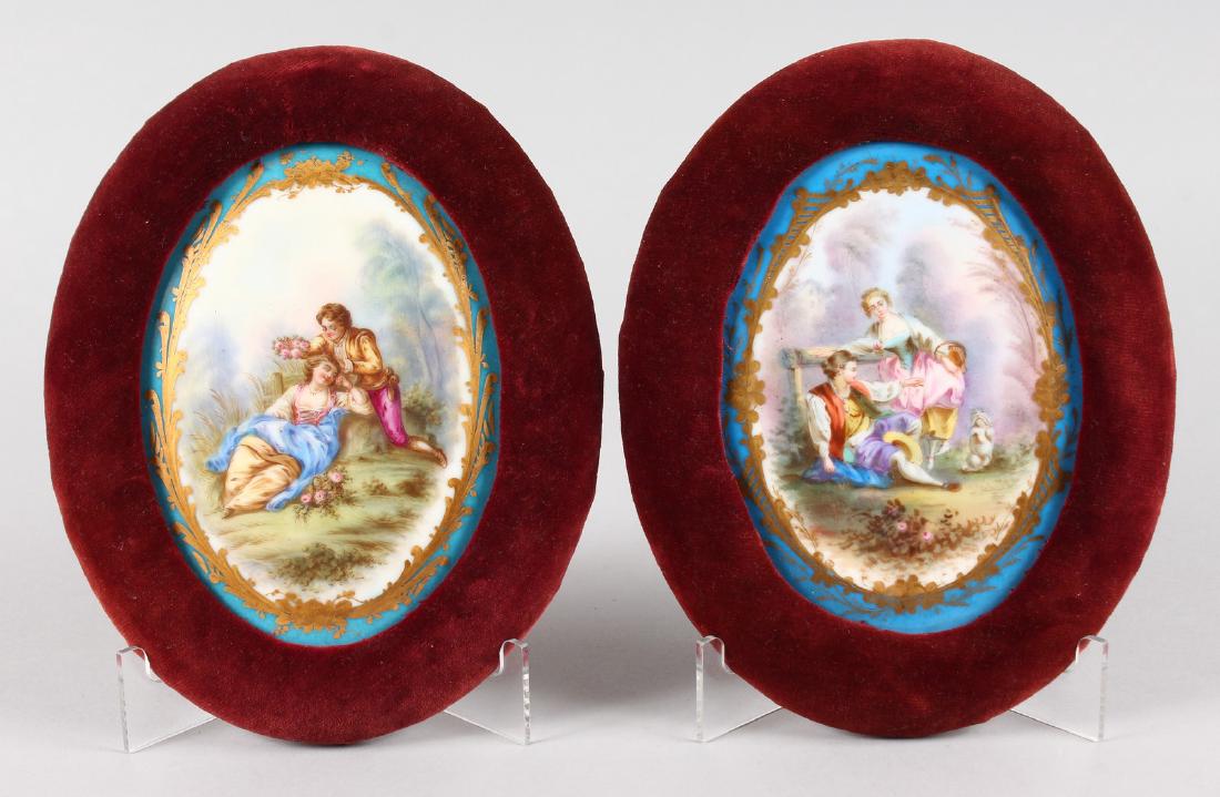 A GOOD PAIR OF SEVRES OVAL PORCELAIN PLAQUES of young: A GOOD PAIR OF SEVRES OVAL PORCELAIN PLAQUES of young lovers. 16cms x 11cms, in velvet frames.