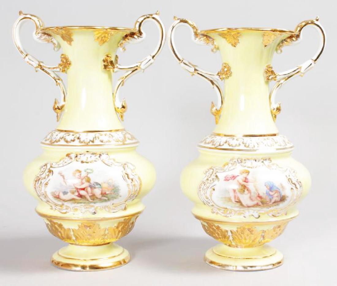 A SUPERB PAIR OF 19TH CENTURY MEISSEN TWO HANDLED VASES: A SUPERB PAIR OF 19TH CENTURY MEISSEN TWO HANDLED VASES with pale yellow ground, edged in gilt and painted with reverse panels of cupids. Cross swords mark in blue. 12.5ins high.
