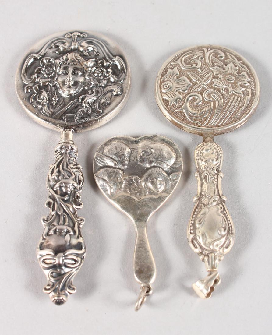 THREE SILVER MINIATURE HAND MIRRORS.: THREE SILVER MINIATURE HAND MIRRORS.