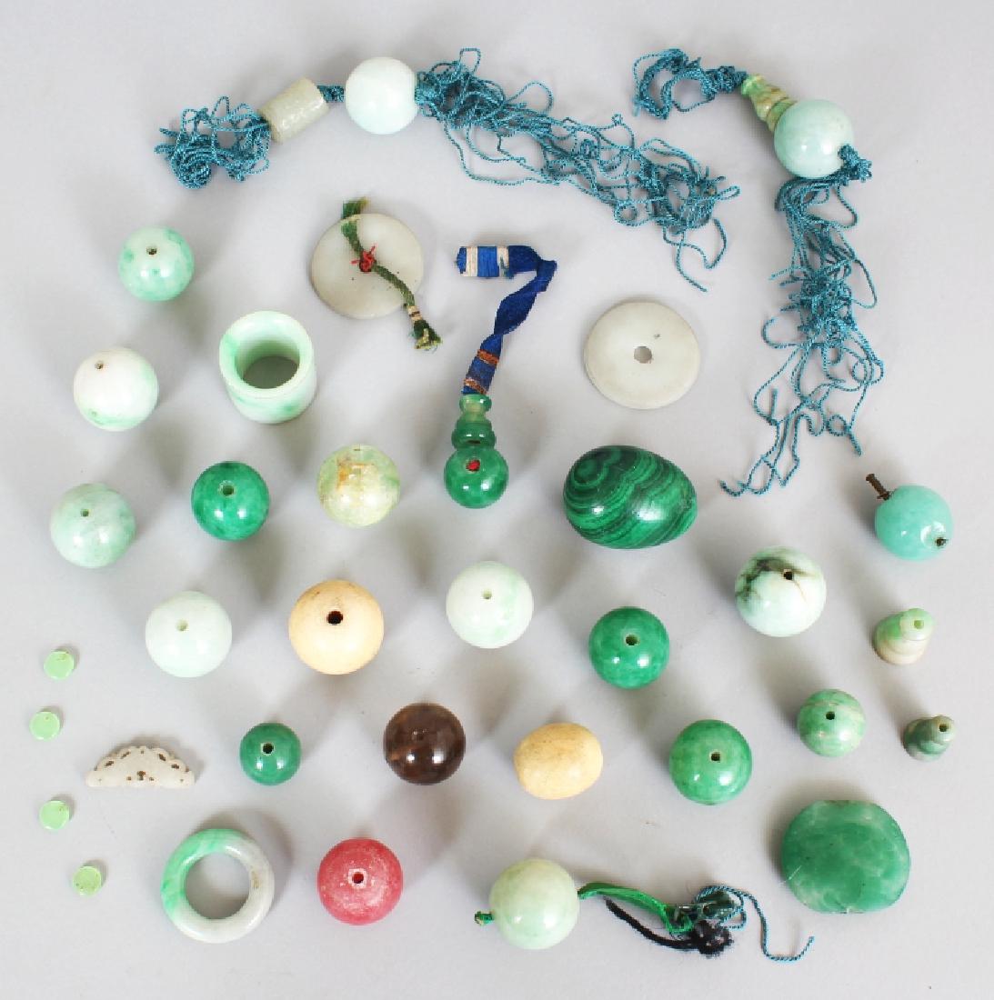 A GOOD ASSORTMENT OF 19TH/20TH CENTURY CHINESE JADE &: A GOOD ASSORTMENT OF 19TH/20TH CENTURY CHINESE JADE & HARDSTONE BEADS AND PENDANTS ETC, the beads of larger than average size, two of the beads bone, the selection also including two white jade discs,