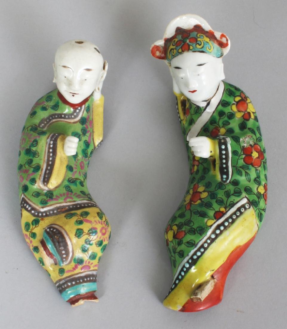 A NEAR PAIR OF CHINESE FAMILLE ROSE RECLINING PORCELAIN: A NEAR PAIR OF CHINESE FAMILLE ROSE RECLINING PORCELAIN FIGURES, possibly Jiaqing period, one of a boy, the other of a Mandarin, each with floral decorated robes, each base unglazed, 6.8in & 6.4in lon