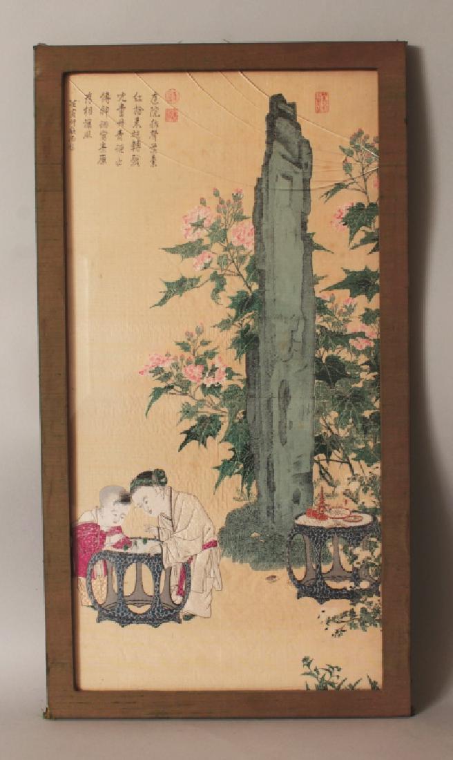 AN UNUSUAL 20TH CENTURY FRAMED CHINESE WEAVED SILK: AN UNUSUAL 20TH CENTURY FRAMED CHINESE WEAVED SILK PICTURE, decorated with calligraphy and with boys playing with spinning tops on a garden seat, the frame 23.8in x 13in.
