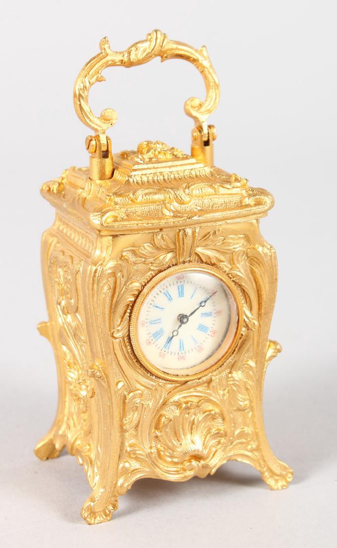 A GILT ROCOCO CASED CARRIAGE CLOCK. 3ins high.: A GILT ROCOCO CASED CARRIAGE CLOCK. 3ins high.