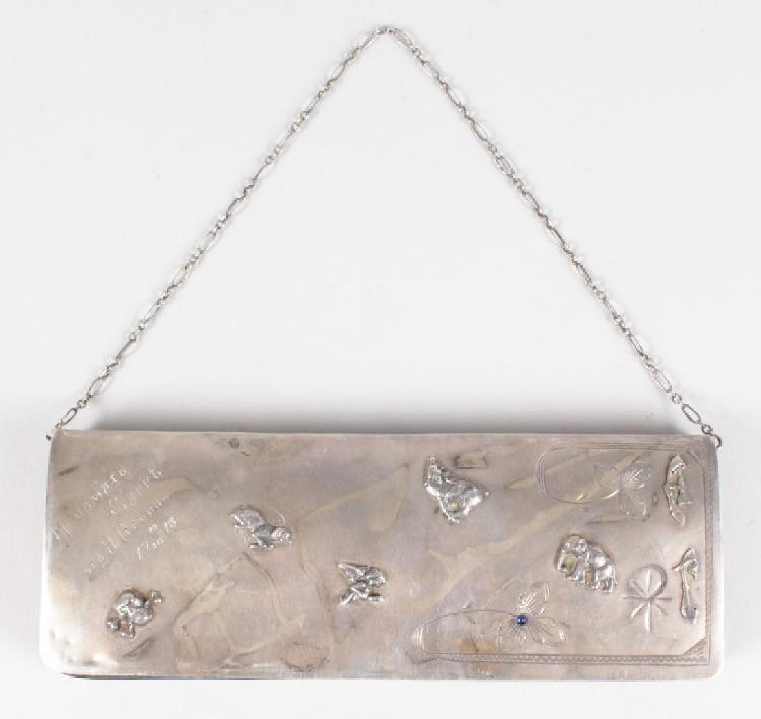 A LONG RUSSIAN SILVER PURSE with skull and bone,: A LONG RUSSIAN SILVER PURSE with skull and bone, elephant, dog and other emblems, dated 19/10/16, with leather interior. 8.5ins long.