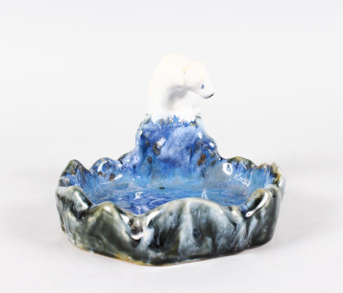 A ROYAL DOULTON STONEWARE ASHTRAY as a polar bear: A ROYAL DOULTON STONEWARE ASHTRAY as a polar bear sitting on a rock overlooking a pool. 5.5ins diameter. No. 8715.