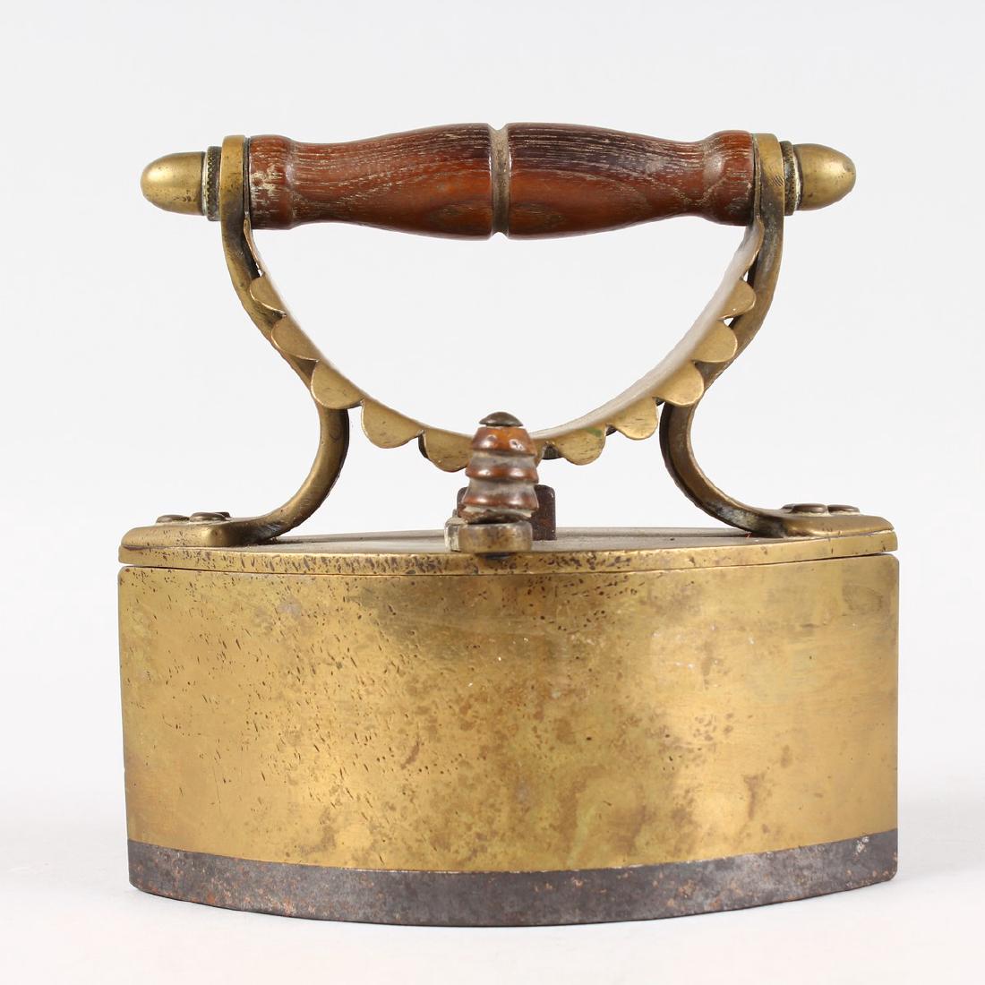A HEAVY SCOTTISH BRASS AND IRON IRON with turned wood: A HEAVY SCOTTISH BRASS AND IRON IRON with turned wood handle. 6.5ins high x 6.5ins long.