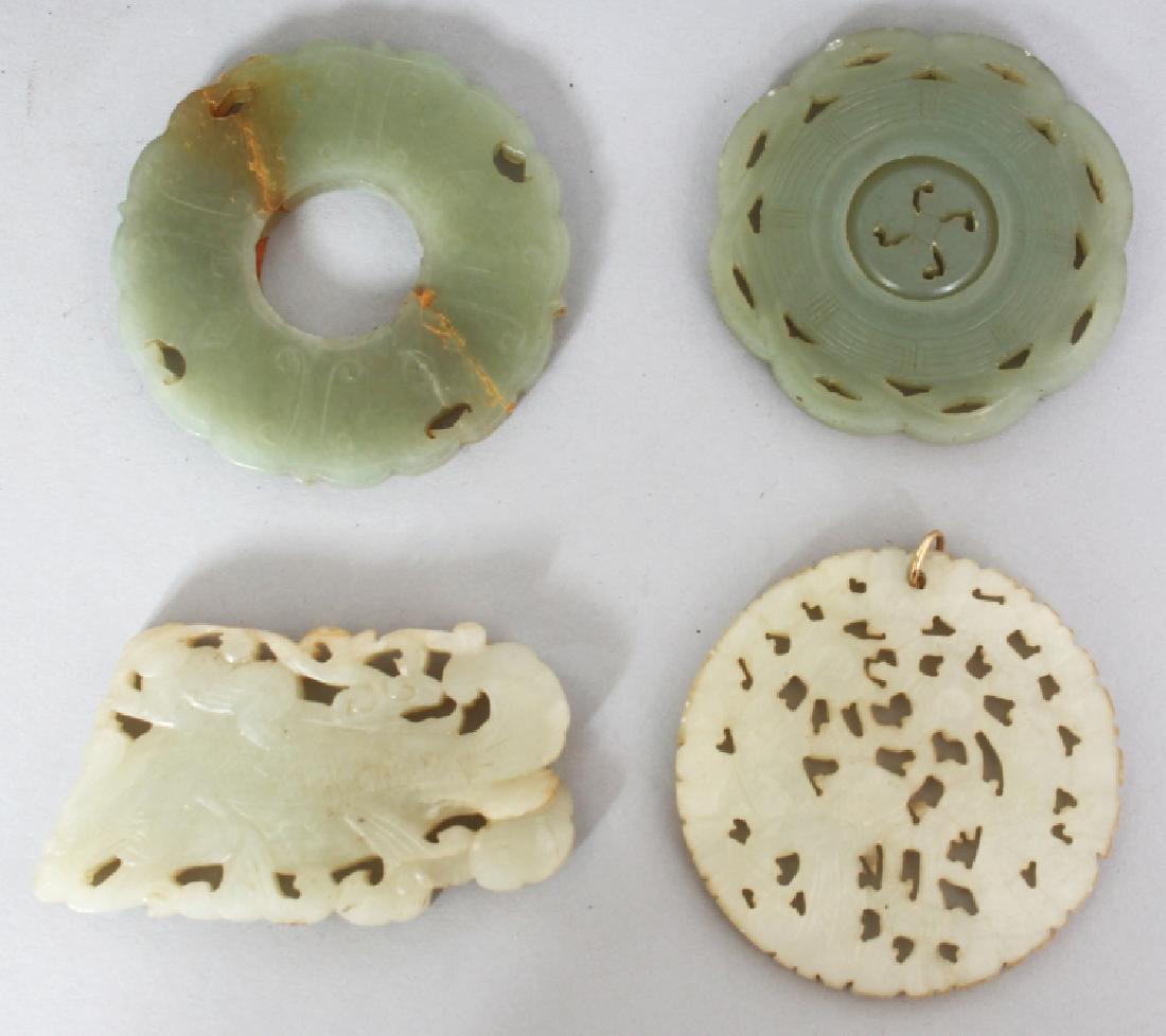 A GROUP OF FOUR CHINESE JADE PENDANTS, the largest (1 of 6)