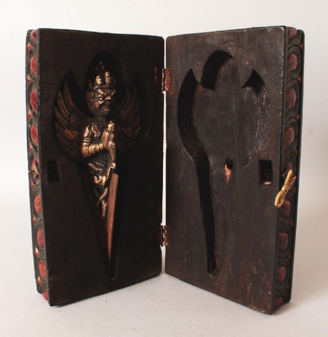 A TIBETAN STYLE BRONZE VAJRA, in a fitted wood box, the: A TIBETAN STYLE BRONZE VAJRA, in a fitted wood box, the box 11.4in x 5.75in x 3.7in high, the vajra 4.1in wide at widest point & 9.4in long.