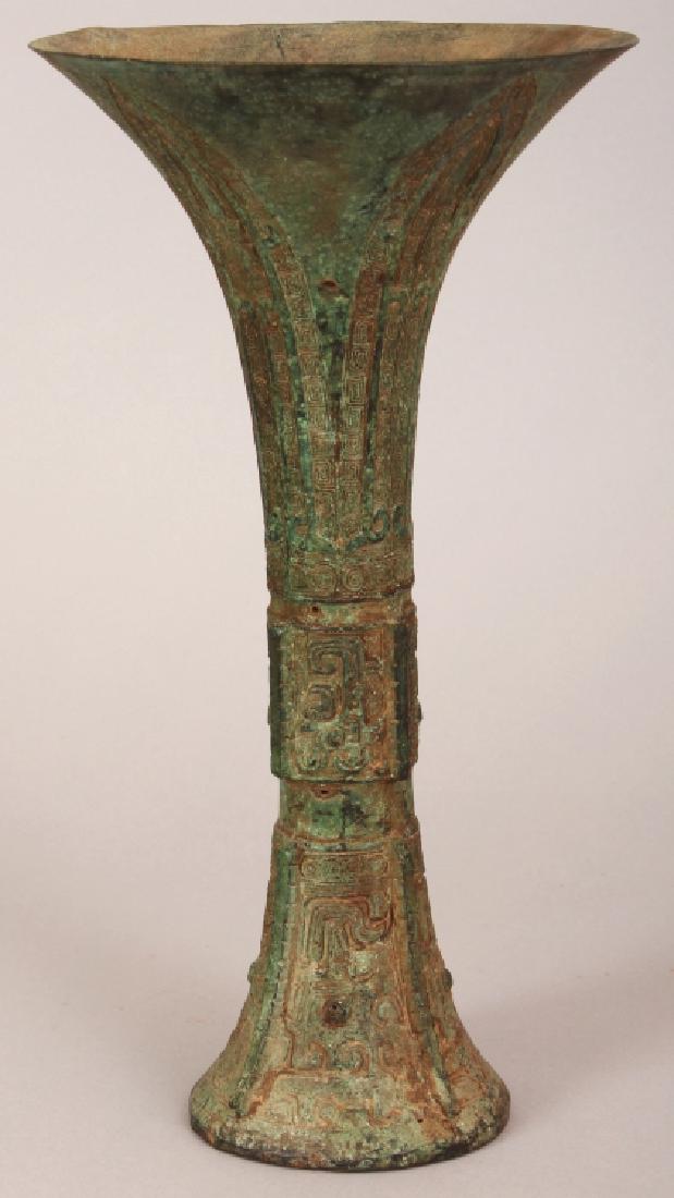 A CHINESE BRONZE GU VASE, of archaic form and design, (1 of 7)