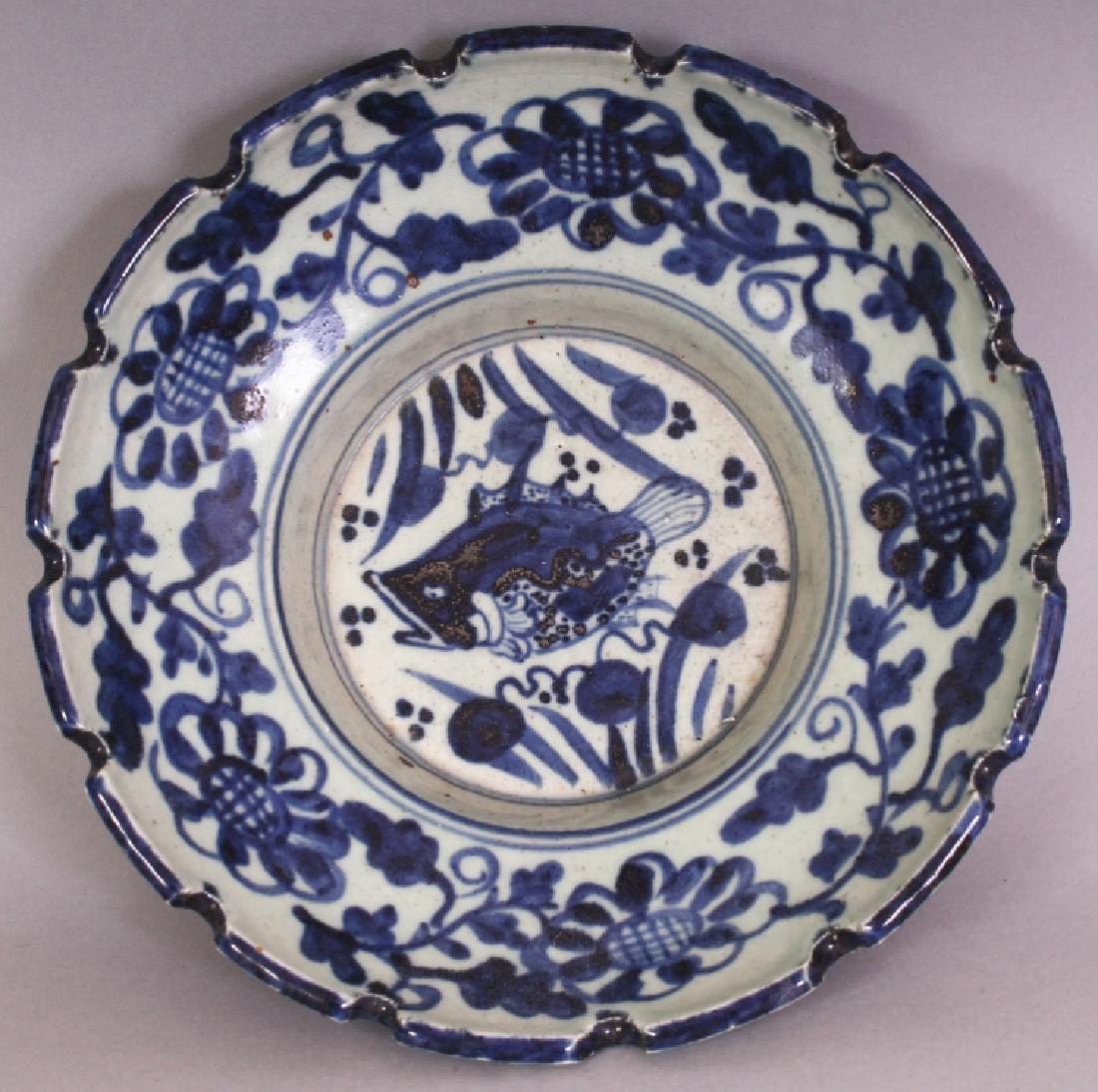 A CHINESE MING STYLE BLUE & WHITE PORCELAIN BOWL, with: A CHINESE MING STYLE BLUE & WHITE PORCELAIN BOWL, with a castellated rim, the interior centre decorated with a swimming carp, the base with a six-character Zhengde mark, 8.25in diameter & 2.5in high.