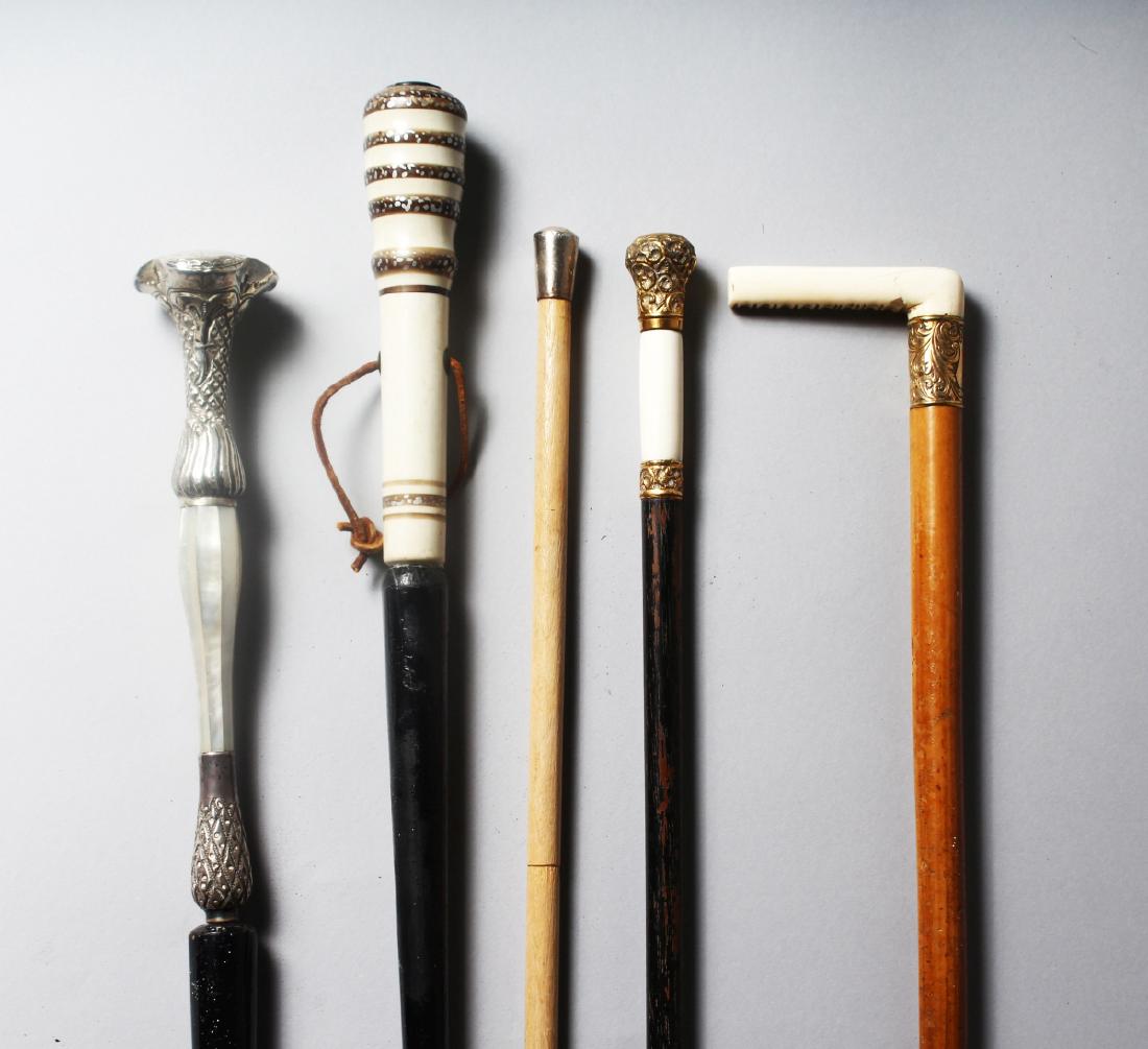 FIVE WALKING STICKS with decorative handles. (1 of 2)