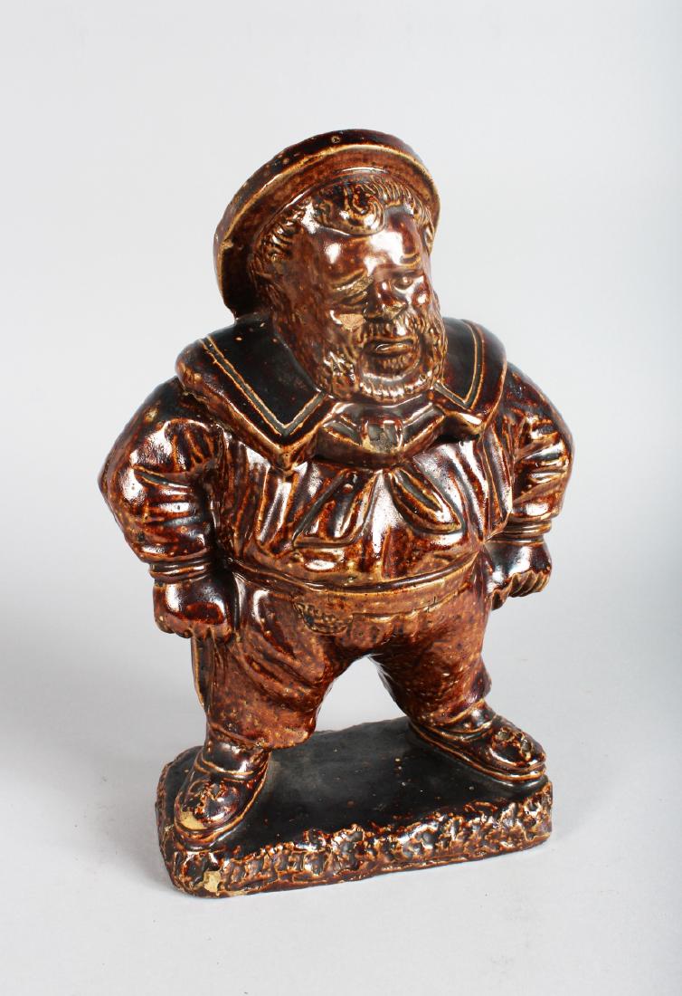 A STONEWARE TOBACCO JAR AND COVER modelled as a man. (1 of 3)