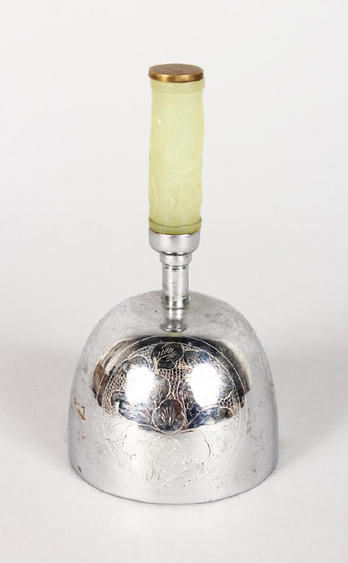 A CHINESE HAND BELL with carved jade handle. 10cms: A CHINESE HAND BELL with carved jade handle. 10cms high.