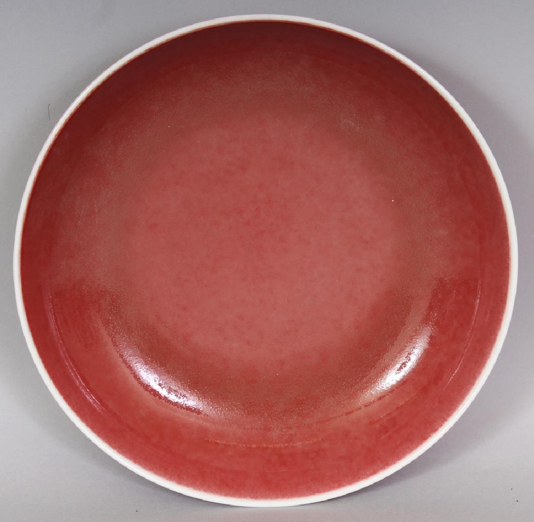 A CHINESE COPPER RED PORCELAIN SAUCER DISH, applied (1 of 5)