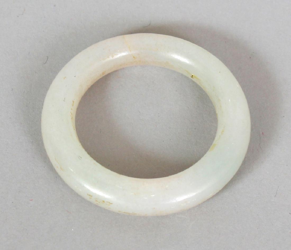 A SMALL CHINESE WHITE JADE BANGLE OR COSTUME RING, (1 of 2)
