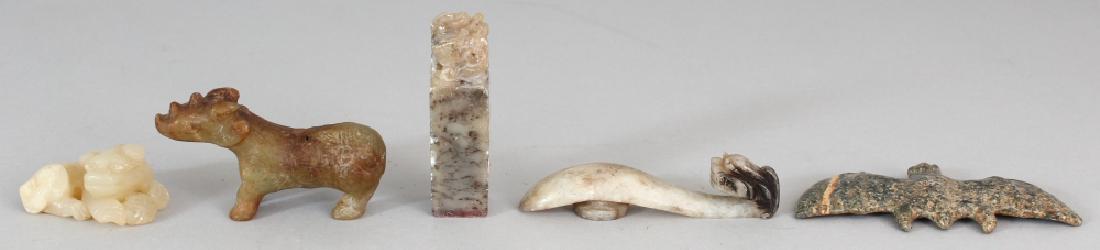 FOUR CHINESE JADE-LIKE CARVINGS, including a belt hook, (1 of 8)