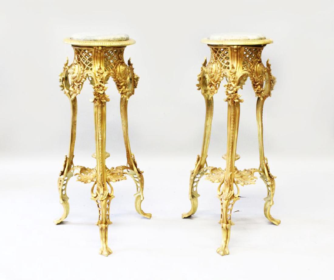 A PAIR OF ROCOCO STYLE GILT BRONZE STANDS, with: A PAIR OF ROCOCO STYLE GILT BRONZE STANDS, with variegated round marble insets (2). 2ft 6ins x 10.5ins diameter.