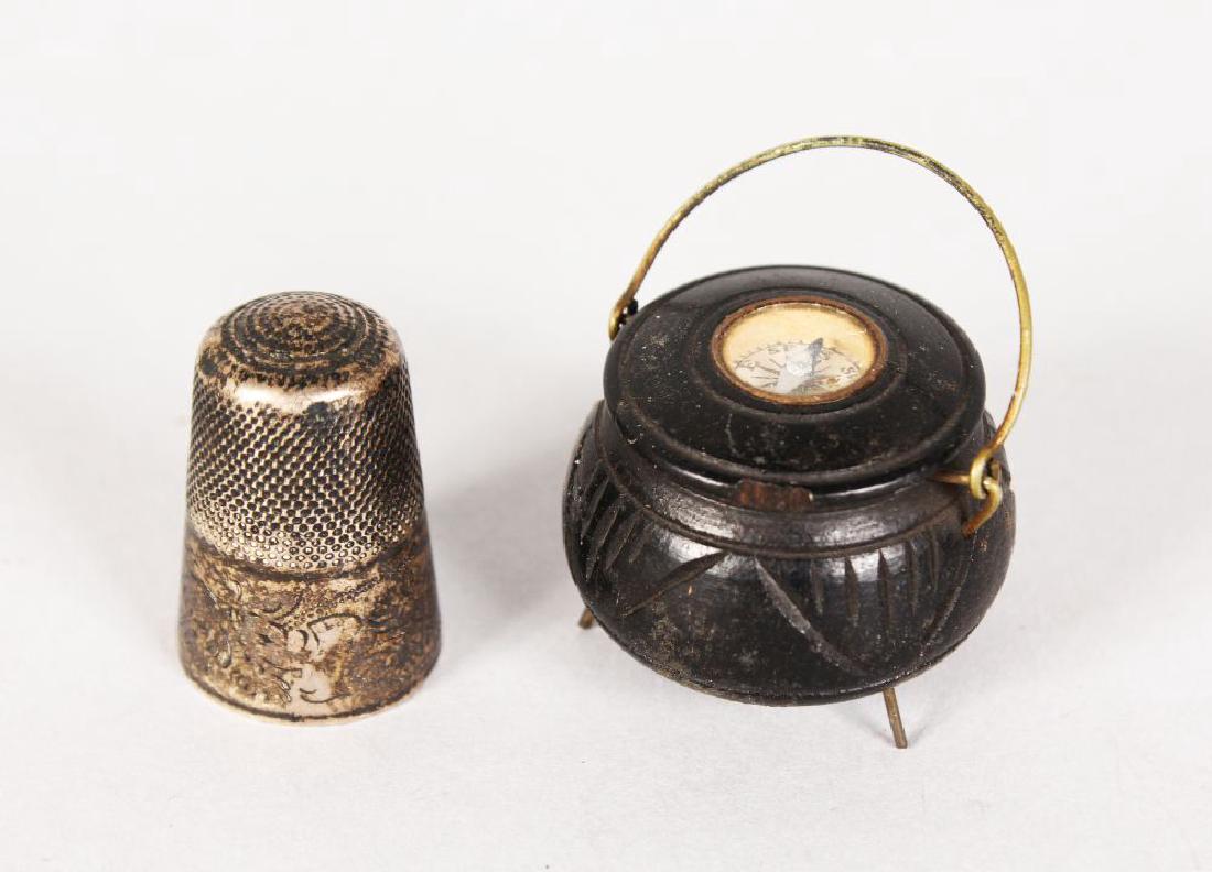 A MINIATURE CAULDRON COMPASS and A VICTORIAN THIMBLE: A MINIATURE CAULDRON COMPASS and A VICTORIAN THIMBLE (2).