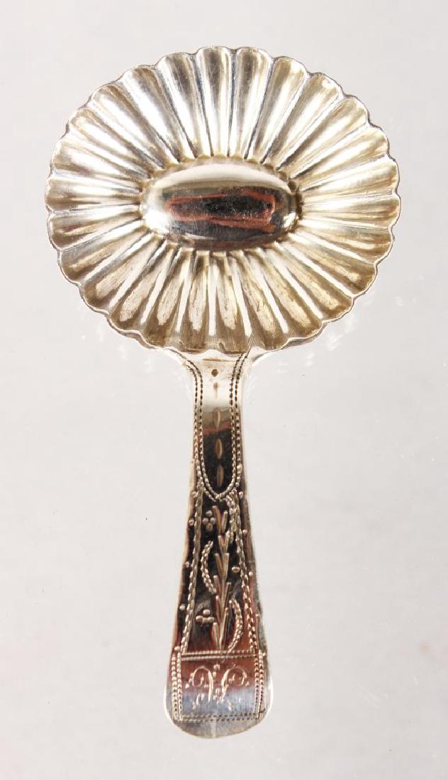 A GEORGE III BRIGHT CUT CADDY SPOON with shell bowl.: A GEORGE III BRIGHT CUT CADDY SPOON with shell bowl. 7cms long. London 1802. Maker: John Thompson.