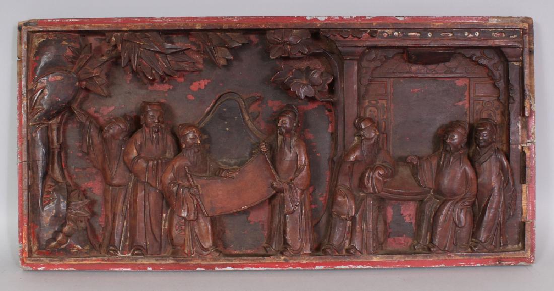 A CHINESE RED LACQUERED CARVED WOOD RECTANGULAR PANEL,: A CHINESE RED LACQUERED CARVED WOOD RECTANGULAR PANEL, decorated with a group of sages in a terrace and bamboo grove setting, 25in x 12in.
