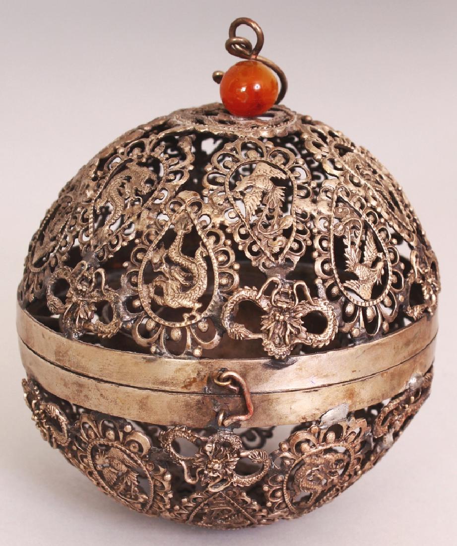 A CHINESE FILIGREE PIERCED SILVER-METAL INCENSE BALL,: A CHINESE FILIGREE PIERCED SILVER-METAL INCENSE BALL, 3.7in diameter.