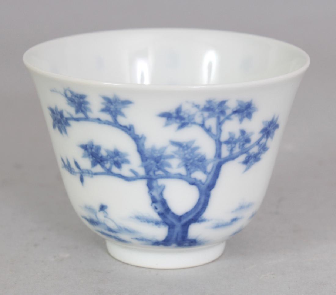 A GOOD QUALITY CHINESE BLUE & WHITE PORCELAIN WINE CUP,: A GOOD QUALITY CHINESE BLUE & WHITE PORCELAIN WINE CUP, decorated with a rabbit beneath a tree and also with calligraphy and an artist’s seal, the base with a six-character Kangxi mark, 2.6in diamet