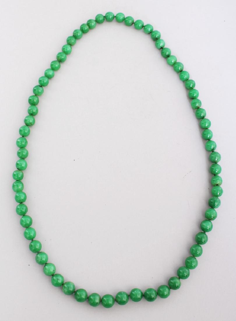 A STRING OF CHINESE APPLE GREEN JADE BEADS, each bead (1 of 3)