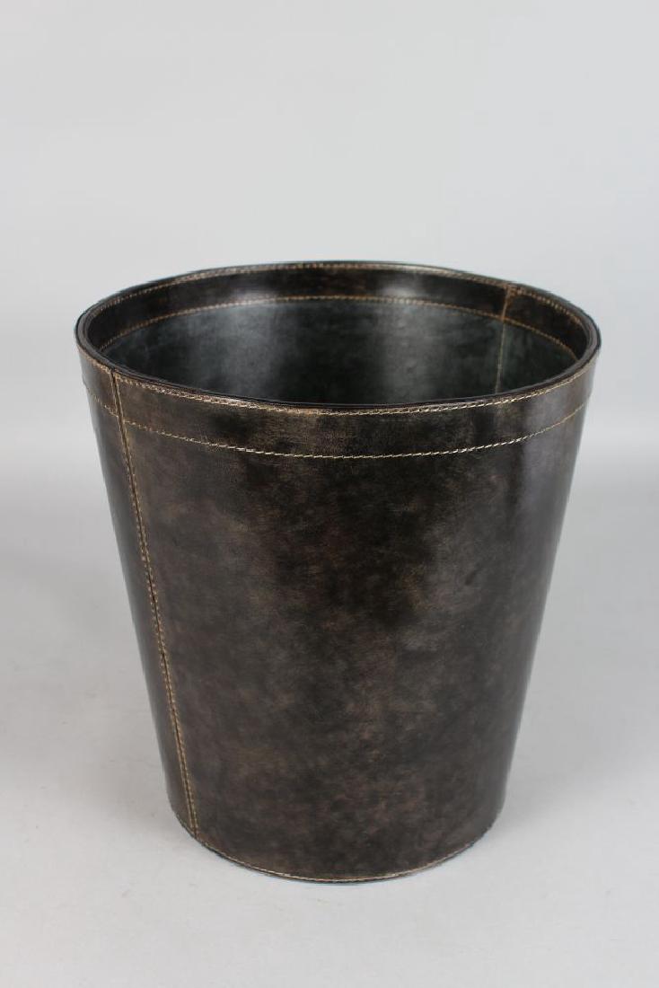 A LEATHER MOUNTED WASTE PAPER BIN.  12ins high, 11.5ins (1 of 2)