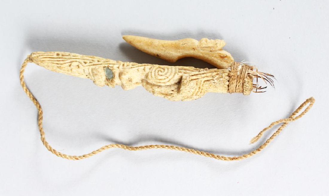 MAORI FISH HOOK, NEW ZEALAND Matau Carved bone,: MAORI FISH HOOK, NEW ZEALAND Matau Carved bone, glass inset mirrored eyesflax, the barb fixed at the base and bound tightly again with muka (flax fibre) cord. Height 5ins.