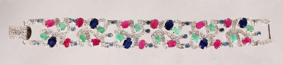 A SILVER, SAPPHIRE, RUBY AND EMERALD WIDE BRACELET. (1 of 3)