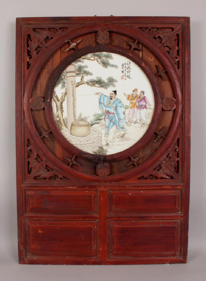 A CHINESE WOOD FRAMED FAMILLE ROSE CIRCULAR PORCELAIN (1 of 6)