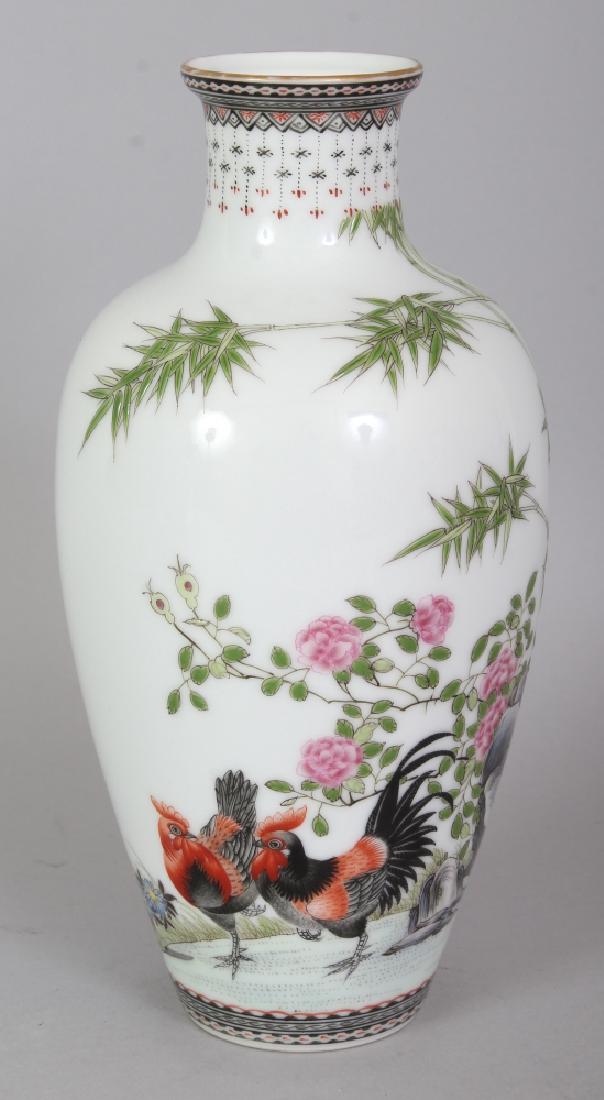 A GOOD QUALITY CHINESE FAMILLE ROSE PORCELAIN VASE,: A GOOD QUALITY CHINESE FAMILLE ROSE PORCELAIN VASE, painted with a cockerel and hen in a garden setting of bamboo, rockwork and peony, the base with a Yongzheng seal mark in blue enamel, 8in high.
