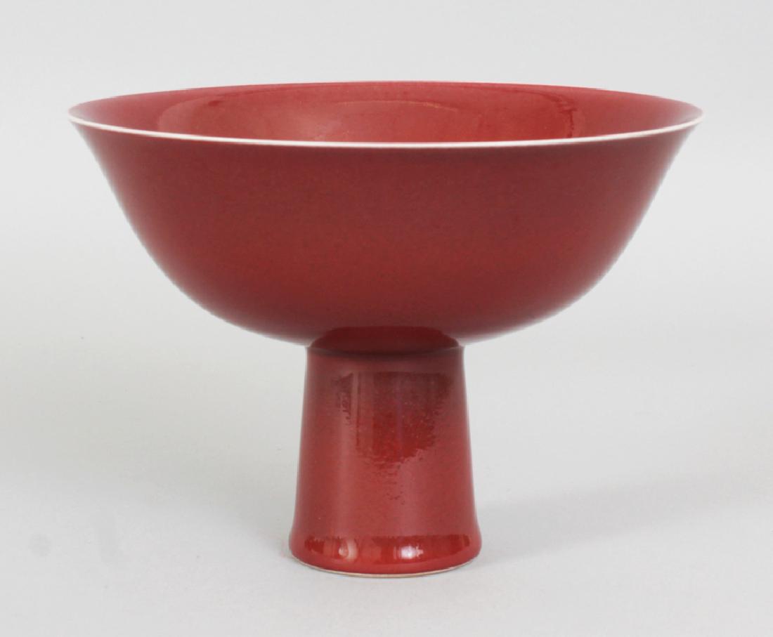 A CHINESE COPPER RED PORCELAIN STEM BOWL, the inside of (1 of 4)
