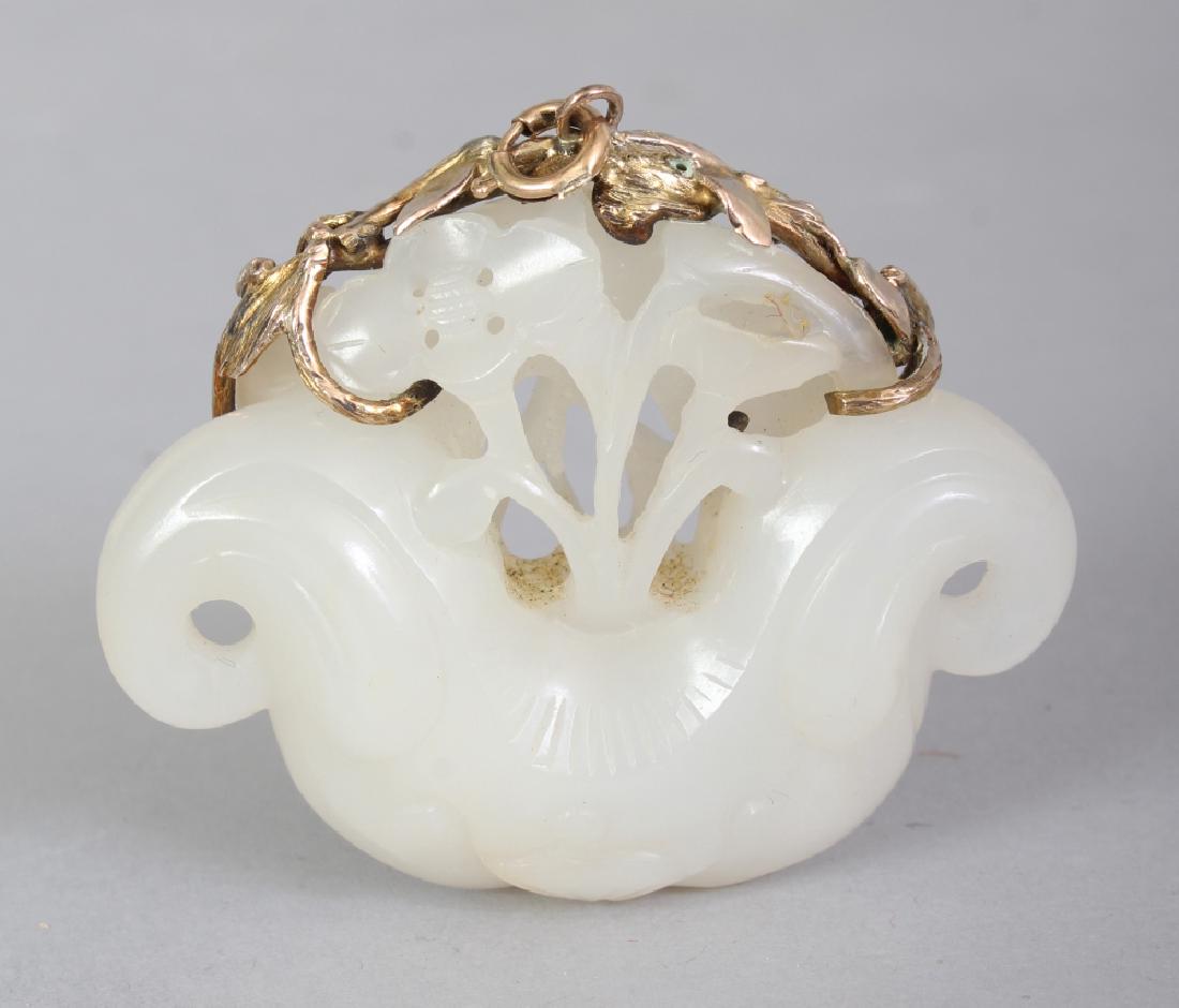 A CHINESE WHITE JADE PENDANT, with a gilt metal clasp, (1 of 2)