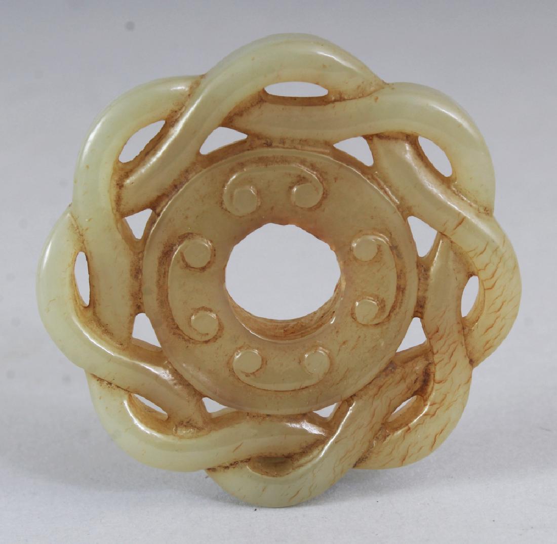 A CHINESE PIERCED CELADON JADE CIRCULAR PENDANT, with a (1 of 3)