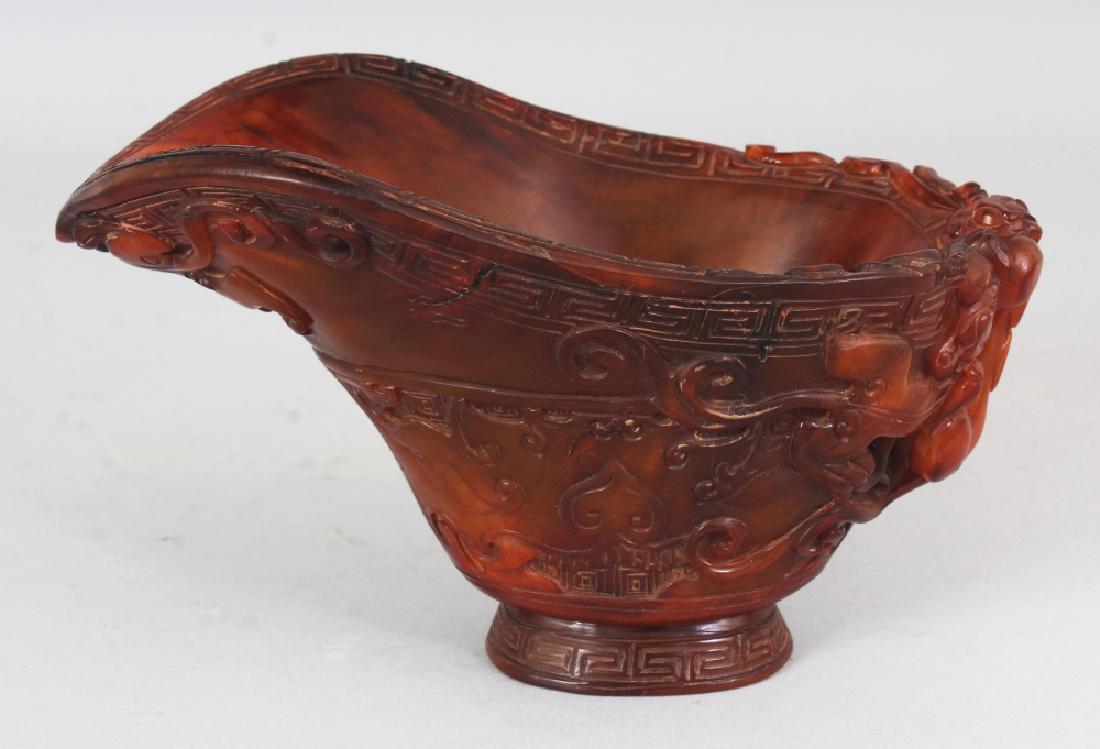 A CHINESE HORN STYLE LIBATION CUP, of larger than (1 of 10)