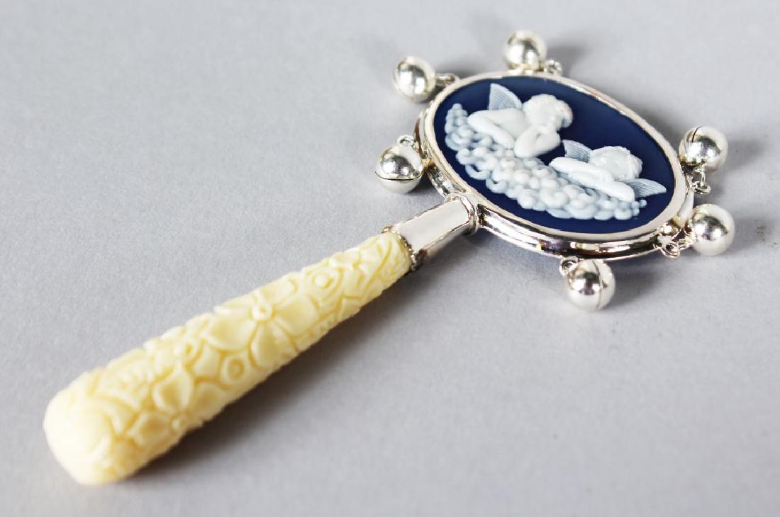 A MINIATURE SILVER CAMEO RATTLE.: A MINIATURE SILVER CAMEO RATTLE.