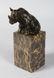 MILO A BRONZE SEATED RHINO. 3.5ins high. Signed, on