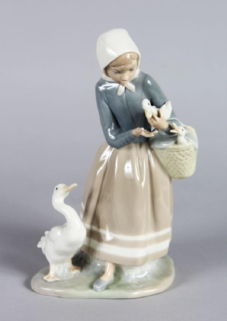 A LLADRO PORCELAIN FIGURE OF A YOUNG GOOSE GIRL, one in (1 of 2)