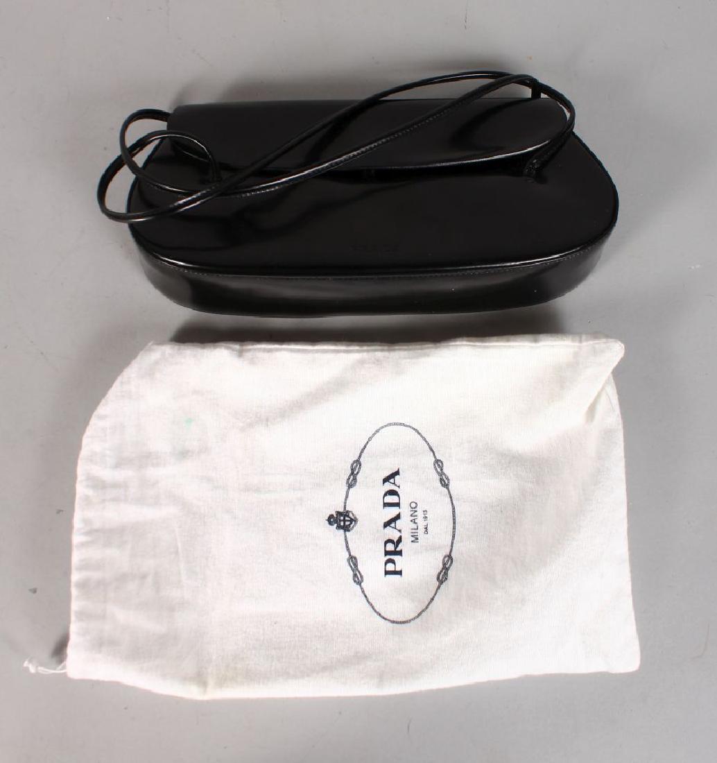 A PRADA BLACK LEATHER EVENING BAG including DUST BAG. (1 of 1)
