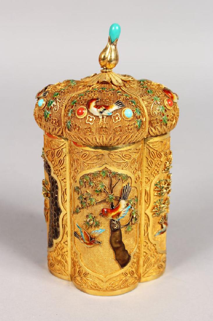 A GOOD SILVER GILT AND ENAMEL FILIGREE SHAPED BOX AND: A GOOD SILVER GILT AND ENAMEL FILIGREE SHAPED BOX AND COVER, decorated with panels of birds in coloured enamels. Impressed SILVER. 16cms high.
