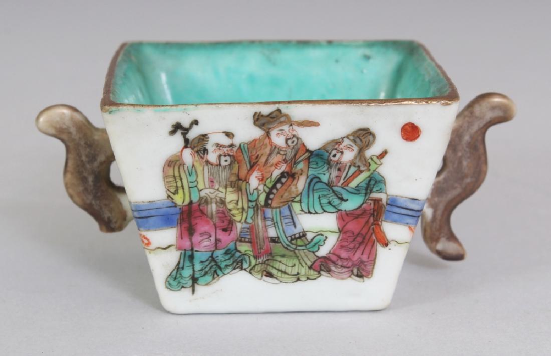 A CHINESE TONGZHI MARK & PERIOD TWO-HANDLED FAMILLE: A CHINESE TONGZHI MARK & PERIOD TWO-HANDLED FAMILLE ROSE PORCELAIN CUP, the sides of the flaring square-section body painted to one side with a scene of the Fu Lu Shou deities, the interior turquoise,