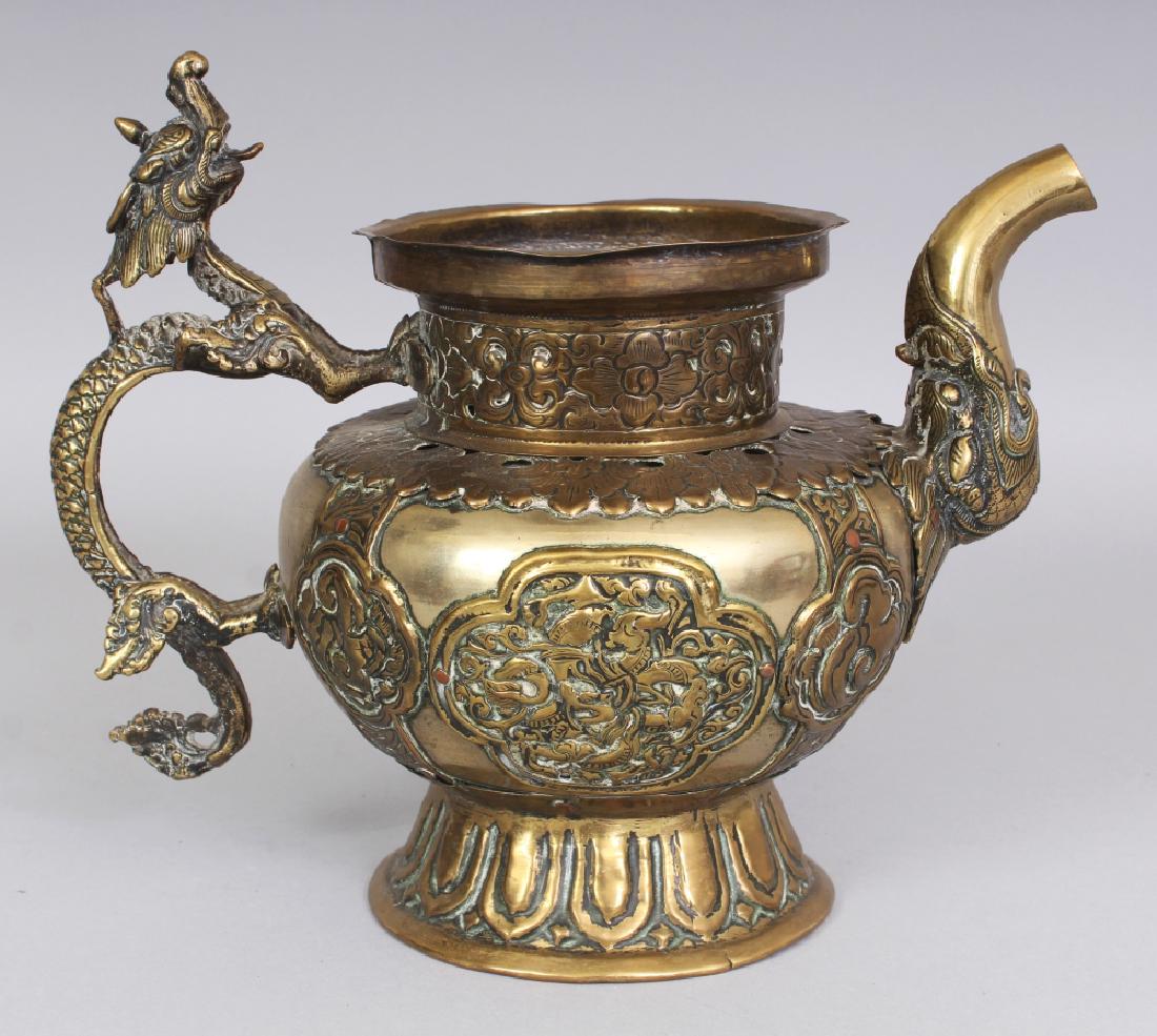 A 19TH CENTURY TIBETAN BRASS OR BRONZE ALLOY EWER, with (1 of 9)