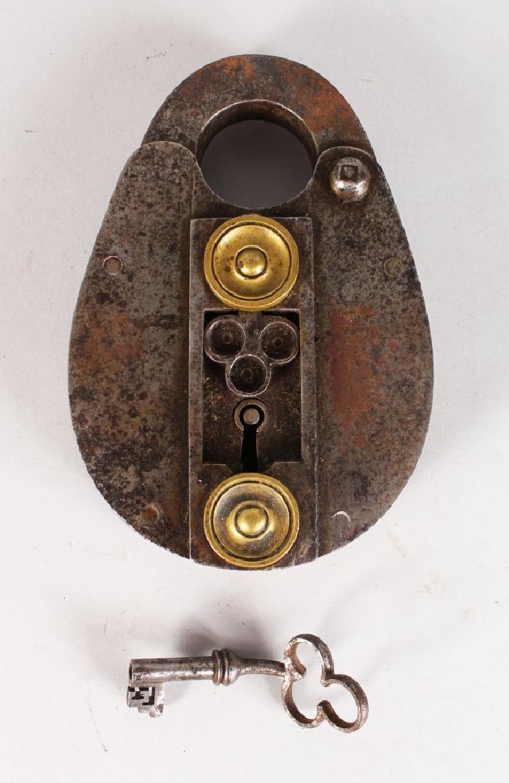A GOOD HEAVY 17TH CENTURY POLISHED STEEL LOCK, with: A GOOD HEAVY 17TH CENTURY POLISHED STEEL LOCK, with small key with cloverleaf handle. 6.5ins long, 4.5ins wide.