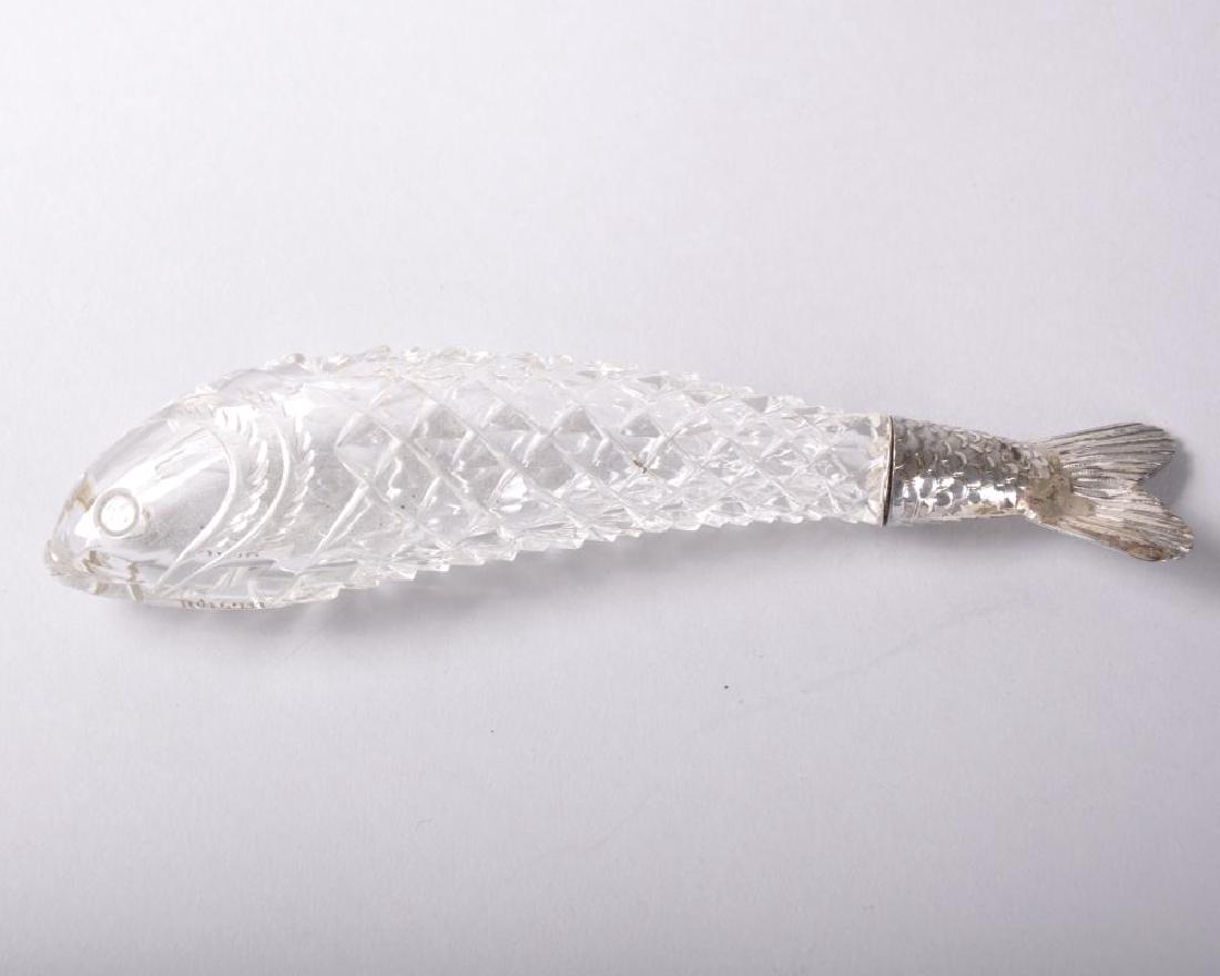 A GOOD CRYSTAL PERFUME BOTTLE in the shape of a FISH: A GOOD CRYSTAL PERFUME BOTTLE in the shape of a FISH with silver tail, London 1906, made in collaboration with THOMAS WEBB who registered it in 1884, Engraved RD 5711, Ref. Alexandra Walker perfume bo