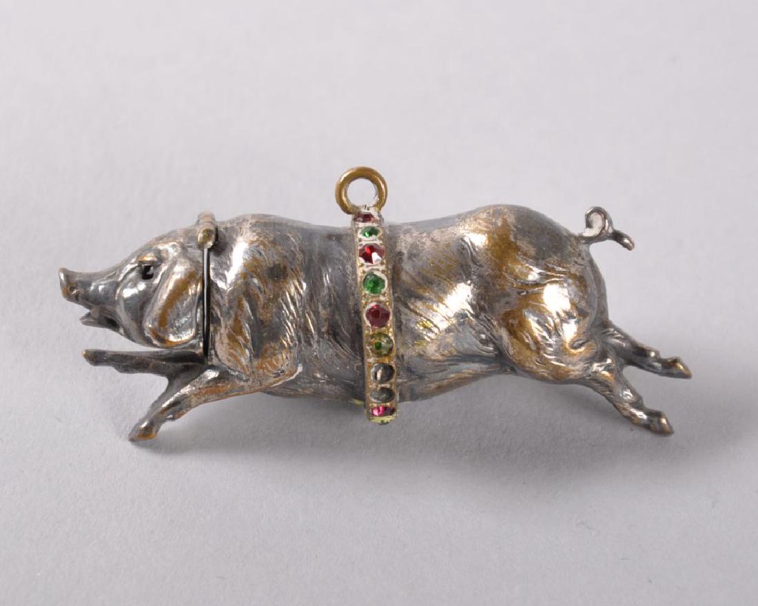 A SMALL SILVER PLATED PERFUME BOTTLE in the shape of a (1 of 2)