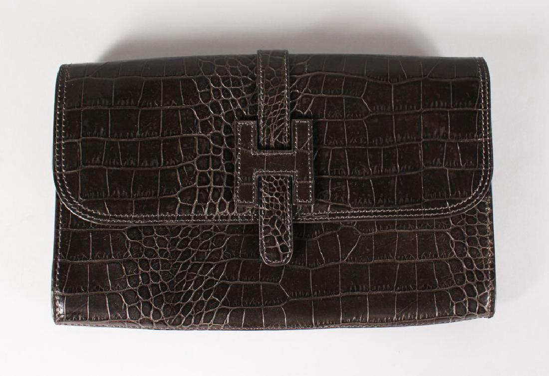 A CROCODILE CLUTCH BAG. (1 of 1)